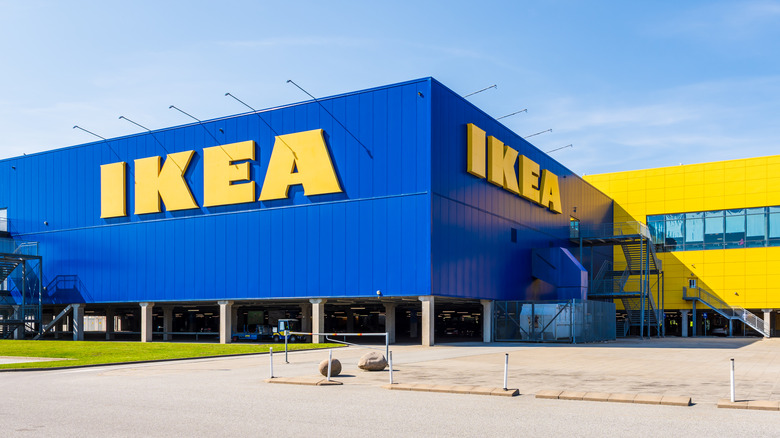 Large IKEA signs on the blue facade of the IKEA store, a swedish multinational company that markets flat-pack furniture.