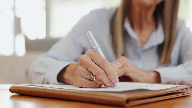 Woman filling out social security paperwork