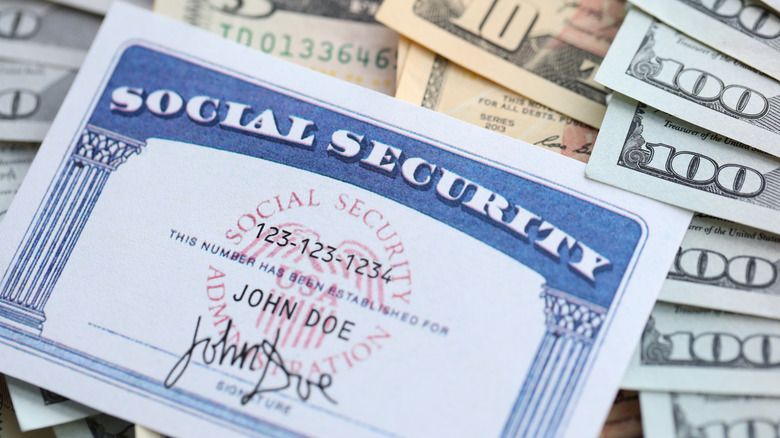 Social Security card sitting on paper money