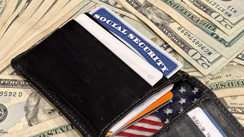 Open wallet with Social Security card on top of $20 bills