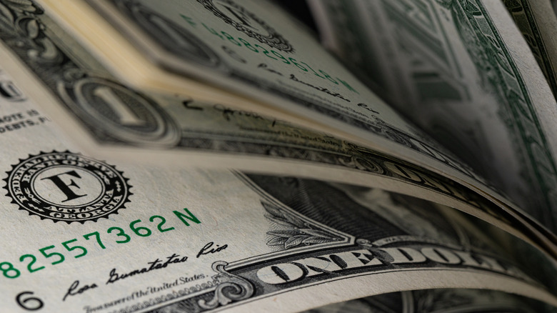Close-up of a pile of one dollar bills.