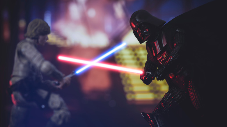 Stars Wars characters fighting with lightsaber weapons