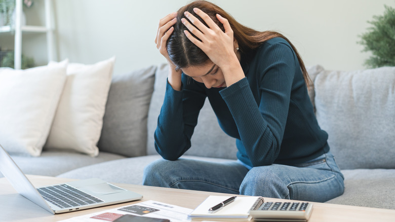 Stressed indivual looking at budget.