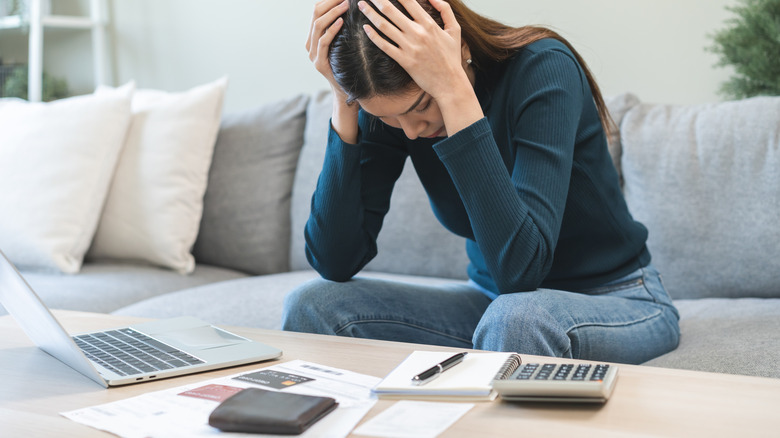 Stressed indivual looking at budget.