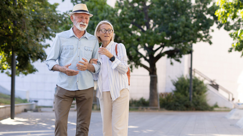 A senior couple in a city park