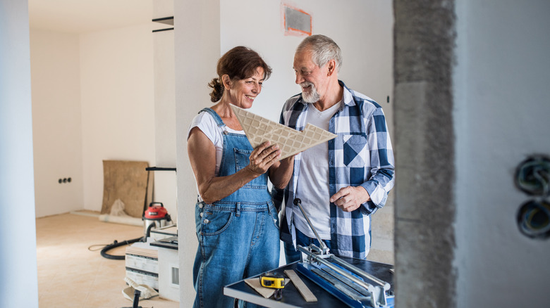 senior couple engaged in a home renovation