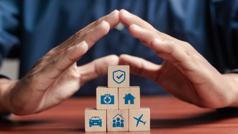 hands over blocks signifying life insurance coverage