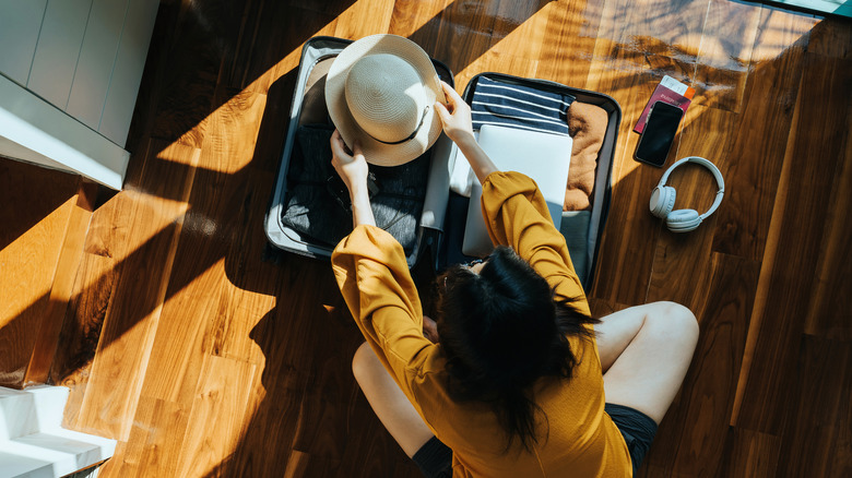 Person packing their suitcase