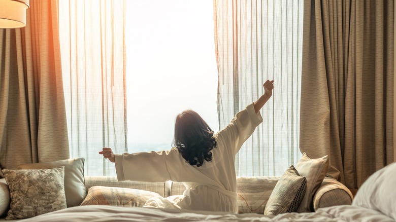 Person stretching in a large hotel room