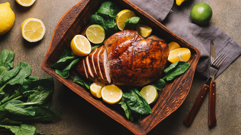 Turkey breast garnished with lemons and greens