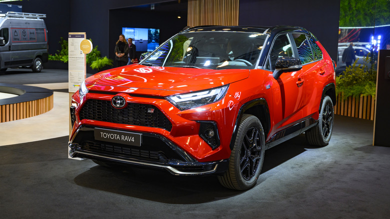 A red Toyota RAV4 GR Sport crossover hybrid performance SUV on display.