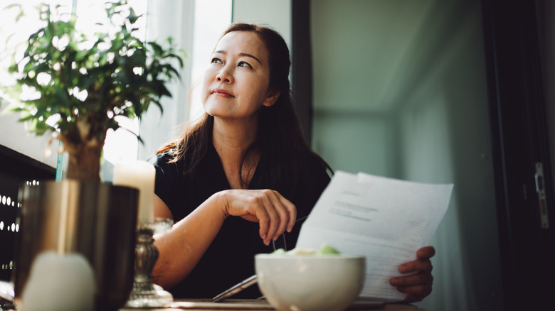 woman looking over financial documents