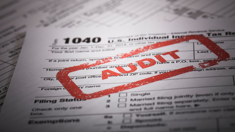 A stock photo of a Red Audit stamp on a 1040 US individual income tax return.