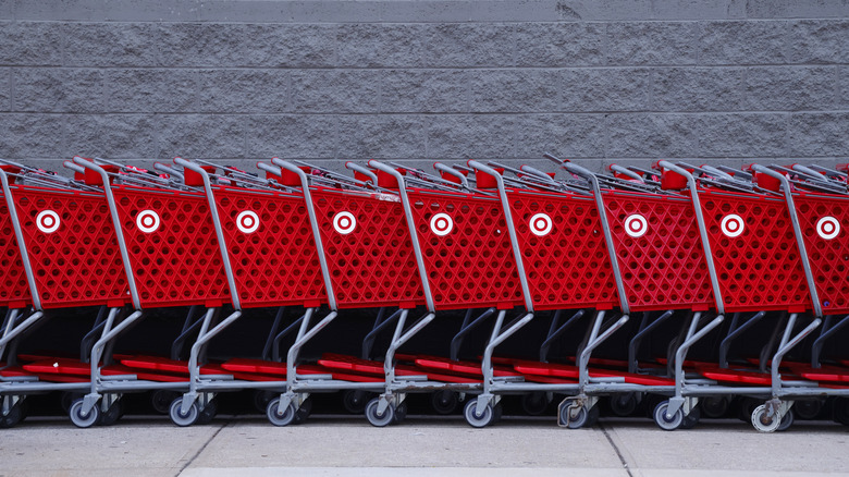 Shopping carts are lined up against a wall outside a Target store