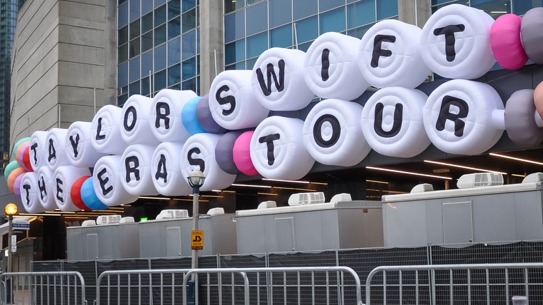 A concert hall exterior draped with massive Taylor Swift The Eras Tour friendship bracelets