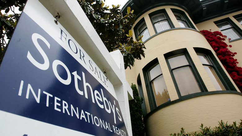 A For Sale Sotheby's sign in front of a property
