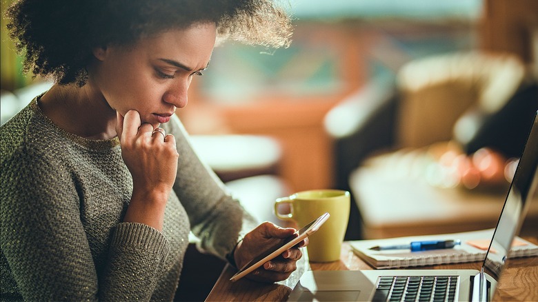 Concerned person staring at phone