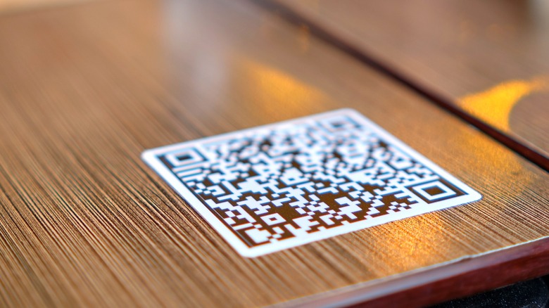 QR code on held smartphone