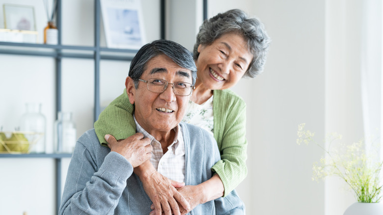 Happy-looking older couple in a living room
