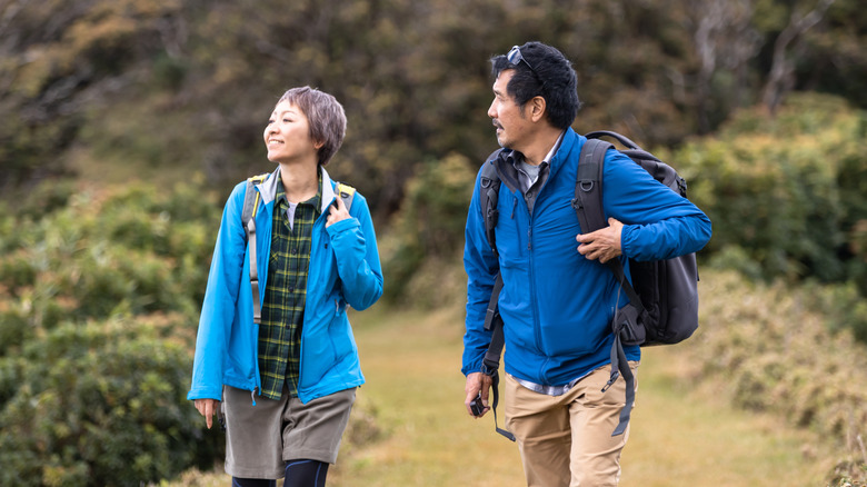 A couple hiking on a mountain trail.