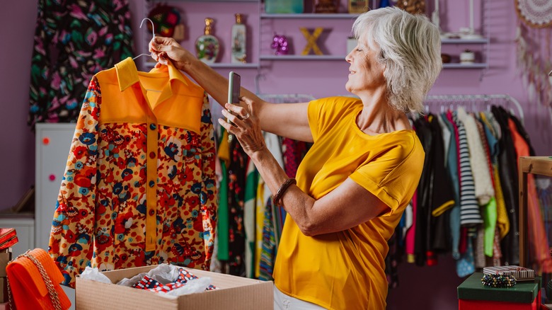 woman taking photo of colorful button up shirt