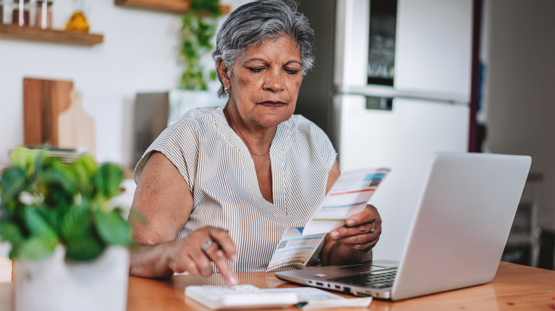 senior looking at her bills