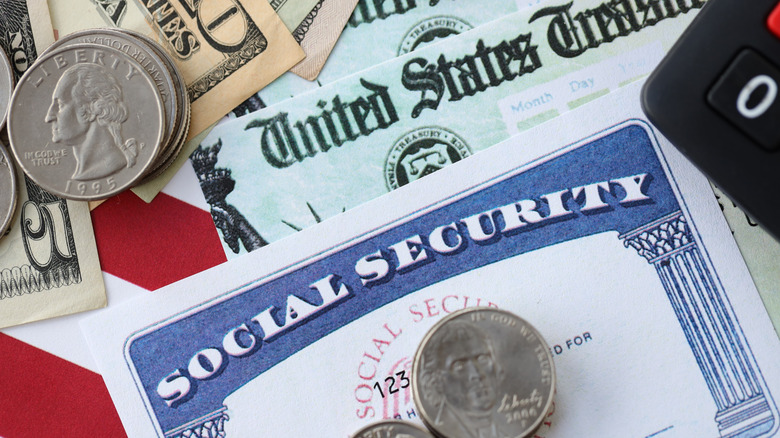 Social Security card and check with coins