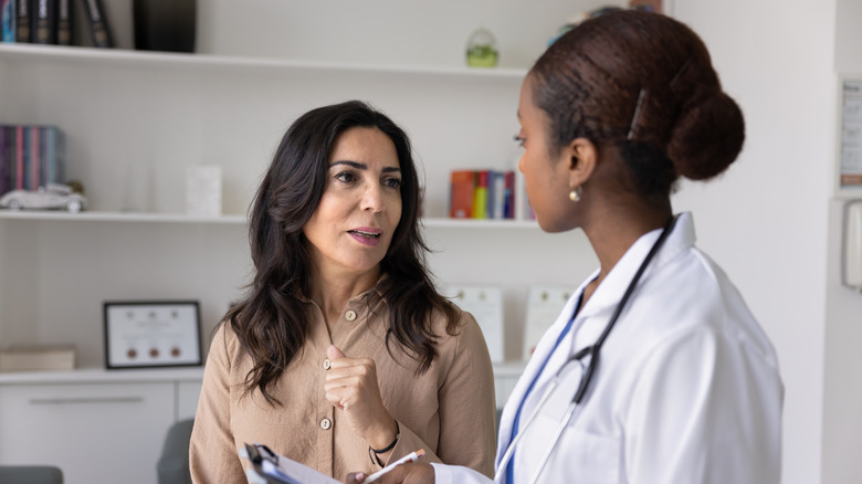 doctor evaluating female patient