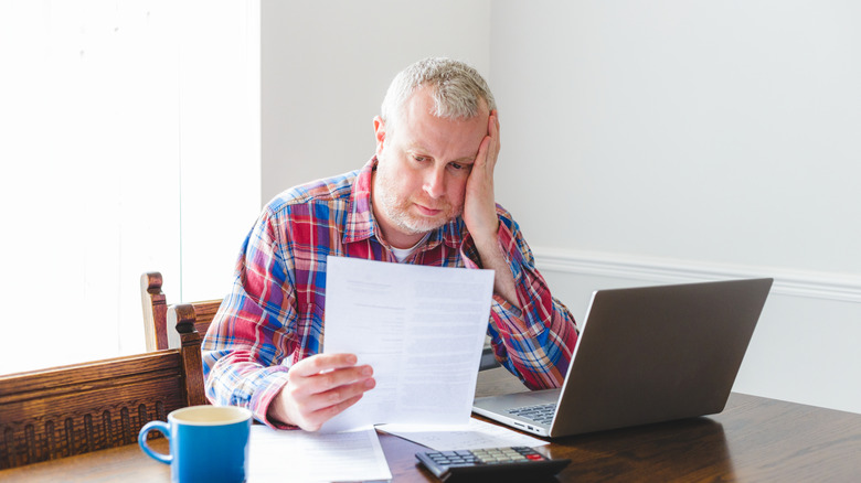 man looking at a surprise tax letter