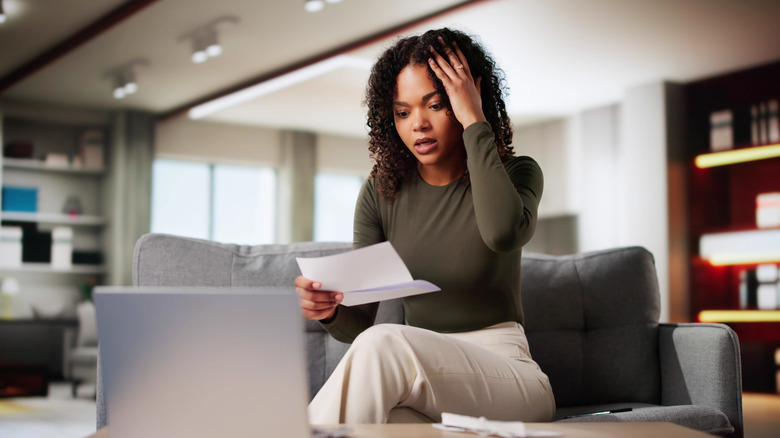 young woman surprised by a letter