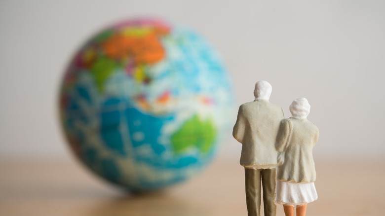 Old senior couple person standing looking for the best places on globe for retirement abroad.