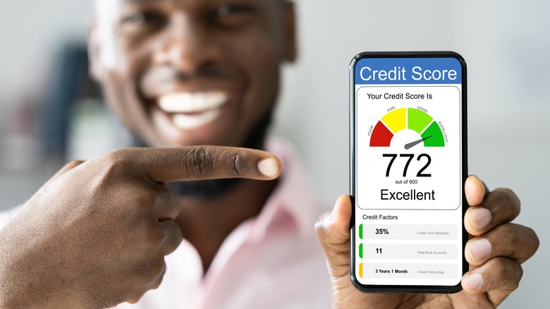 Smiling man pointing to credit score