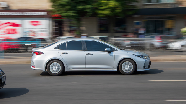 Toyota Corolla driving on a road
