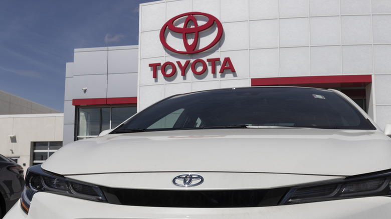 A Toyota in front of a dealership