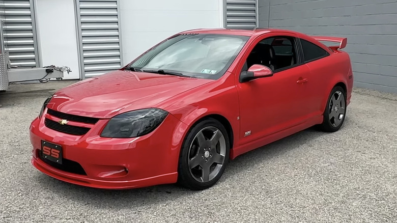 A red 2006 Chevrolet Cobalt SS parked in front of a gray building
