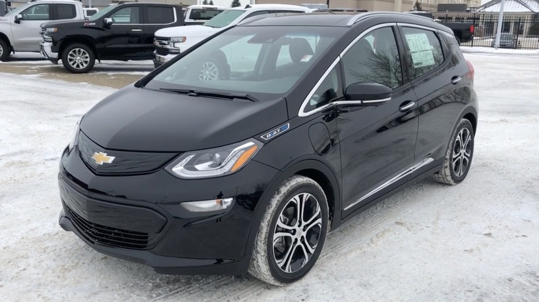 A black 2020 Chevrolet Bolt EV on display in a dealership parking lot