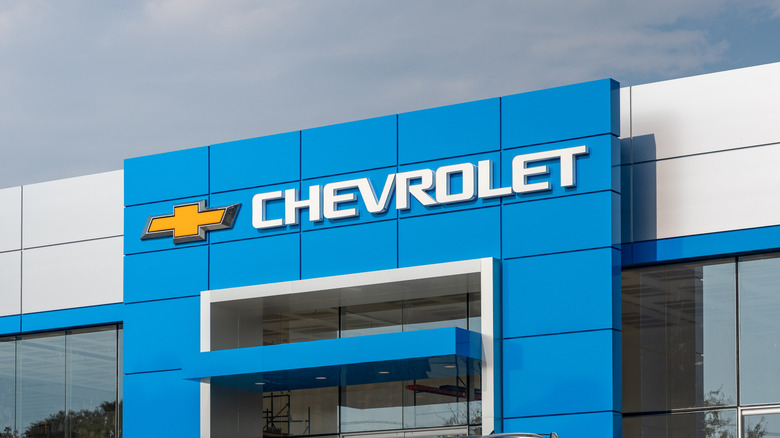 A Chevrolet, GMC, and Buick dealership facade on a cloudy day