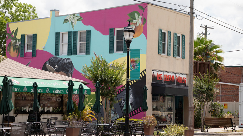 A wall with a colorful mural on the side of an ice cream parlor in Inverness