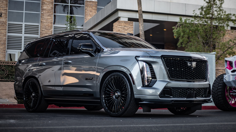 Custom 2025 Cadillac Escalade V parked outdoors during the peak of sunset.
