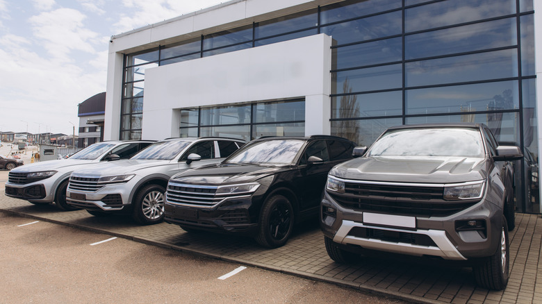 SUV cars stock dealership in parking lot.