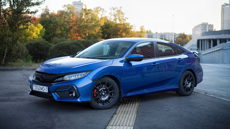 A blue Honda Civic parked on street.