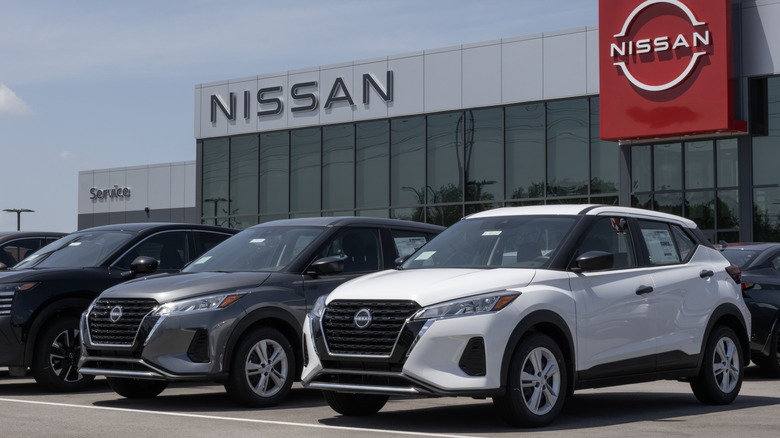 Nissan cars parked outside of a Nissan dealership.