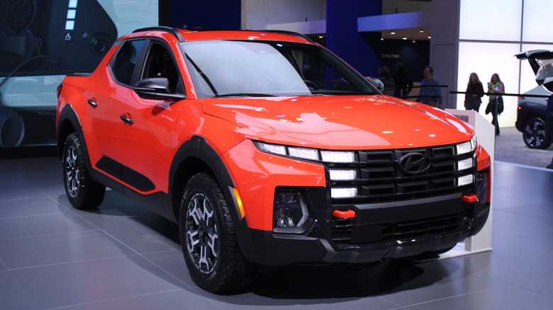 An orange Hyundai Santa Cruz on display.