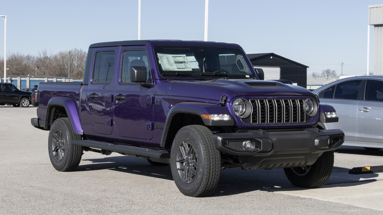 Jeep Gladiator Sport S 4X4 pickup truck display at a dealership.
