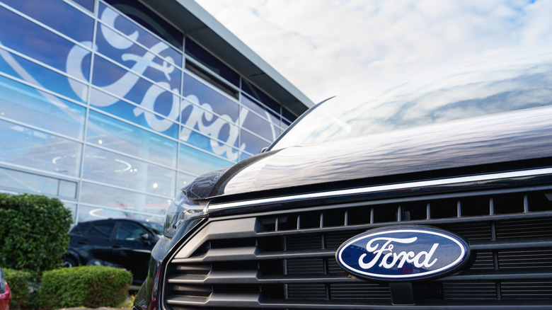 Close-up of Ford logo on car parked outside a dealership in Dusseldorf