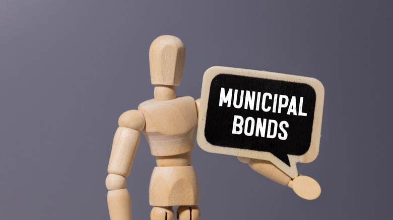 figurine holding sign reading municipal bonds