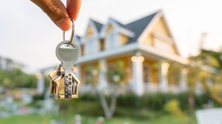 holding keys in front of out of focus home