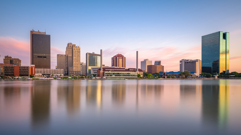 Toledo, Ohio, USA downtown skyline on the Maumee River at dusk.