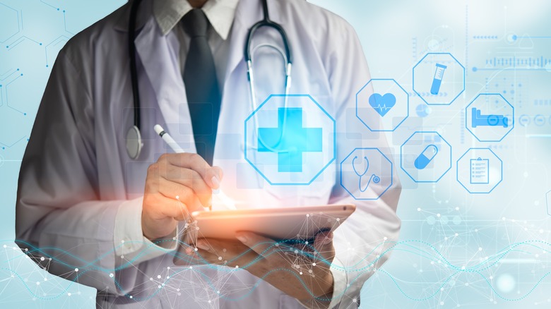 Doctor using tablet surrounded by futuristic medical network.