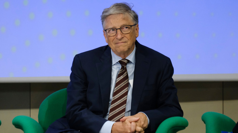 Bill Gates sitting on a chair.